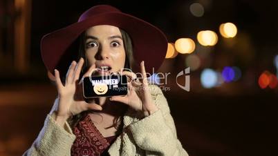 Girl showing smartphone with offer on screen