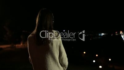 Woman with headphones listening music at night