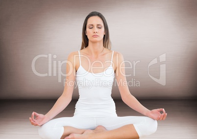 Woman meditating against pink wall