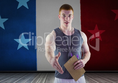 Sport coach shaking his hand against american flag