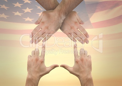 hands making a house against american flag
