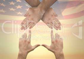 hands making a house against american flag