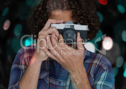 photographer taking a photo with vintage camera. Blue and red bokeh background and overlap