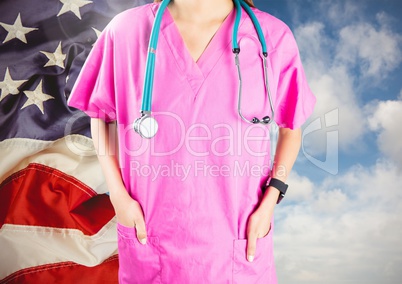 Doctor standing against american flag