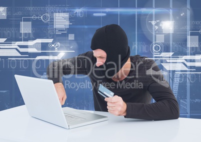 Hacker using a laptop and holding a credit card in front of 3D digital background
