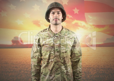 Smiling soldier standing on american flag background