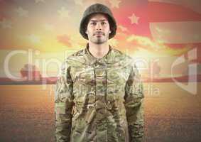 Smiling soldier standing on american flag background