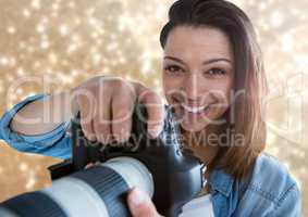 photographer smiling foreground with gold lights behind