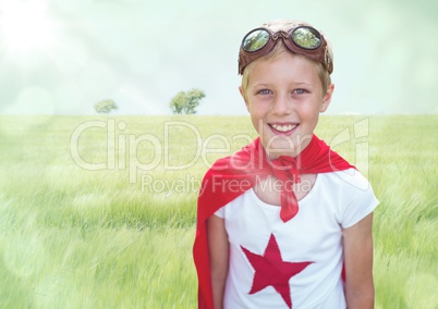 Superhero boy against meadow with flare