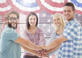 Smiling Friends with hands together against american flag