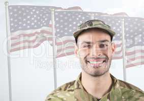 Smiling soldier in front of american flags