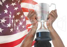 Part of a man holding a cup behind his head against fluttering american flag