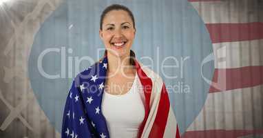 Woman wrapped in american flag against blurry wood panel with hand drawn american flag and flare