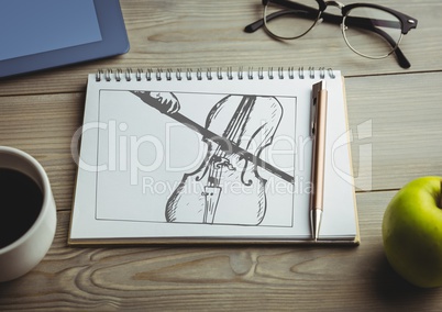 Cello doodle on notepad with coffee and green apple