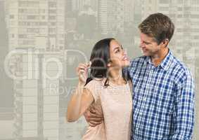 Couple Holding Keys with city high rises