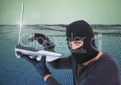 Hacker with hood using a laptop in front of digital number field