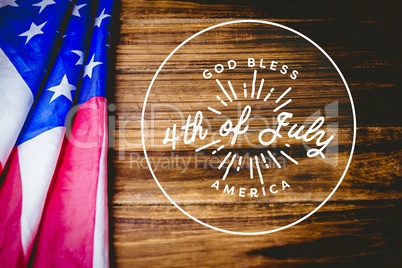 4th of July design on wooden background with american flag