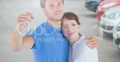 Couple Holding Keys with cars
