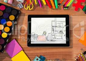 desk with 3d tablet and drawing tools. On the tablet a draw of a office
