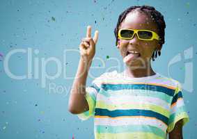 Boy in sunglasses making peace sign against blue background and confetti