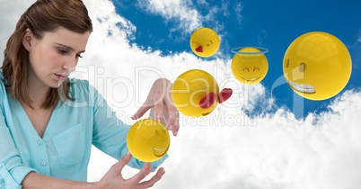 Digital composite of businesswoman with 3d emojis against cloudy sky