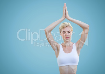 Woman meditating against blue background