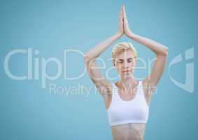 Woman meditating against blue background