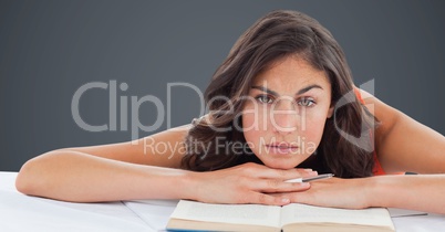 College student at desk against grey background