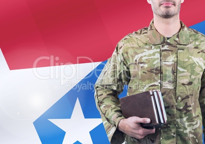 Soldier holding books in front of the american flag