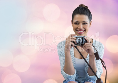 Photographerholding a camera against glowing background