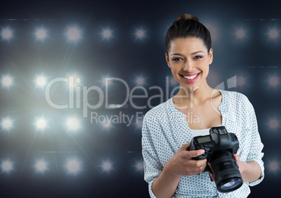 photographer smiling  looking to the photos on camera .stadium lights  background
