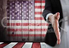 Business woman shaking her hand against american flag