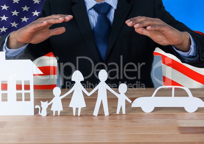 Business man showing a paper family against american flag