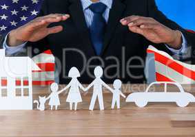 Business man showing a paper family against american flag