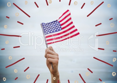 Hand holding american flag against blurry blue wood panel with firework doodles