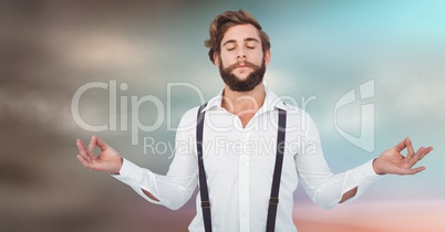 Millennial man meditating against blurry blue brown background