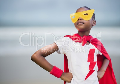 Girl superhero against blurry beach