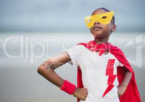Girl superhero against blurry beach