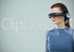Woman in virtual reality headset against light blue background