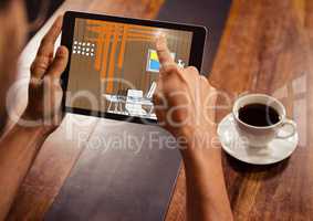 hands with tablet in a coffee shop. Tablet with office lines (brown, orange, blue and yellow)