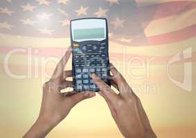 Hands using a calculator against american flag