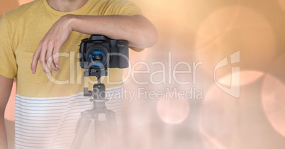 Photographer with camera against glowing background