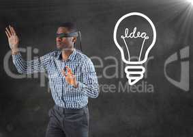 Blindfolded business man against grey wall with flare and white lightbulb graphic