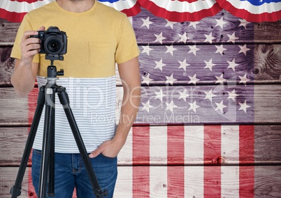 Part of a photographer standing on an american flag background