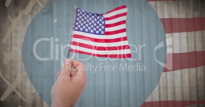 Hand holding american flag against blurry wood panel with hand drawn american flag