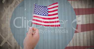 Hand holding american flag against blurry wood panel with hand drawn american flag