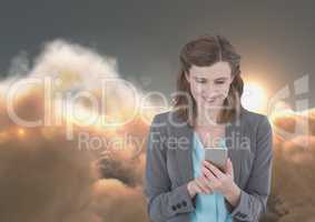 Smiling woman texting in 3D cloudy background