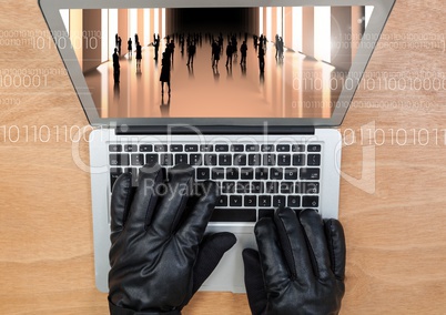 Aerial view of gloved hand typing on a laptop with 3d screen
