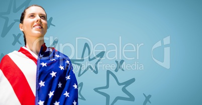 Woman wrapped in american flag against blue background with 3d hand drawn star pattern