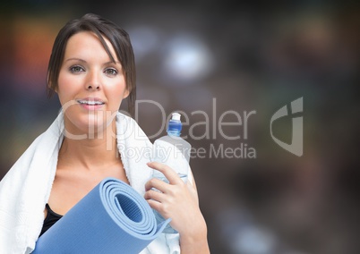 Woman with gym gear against blurry brown background